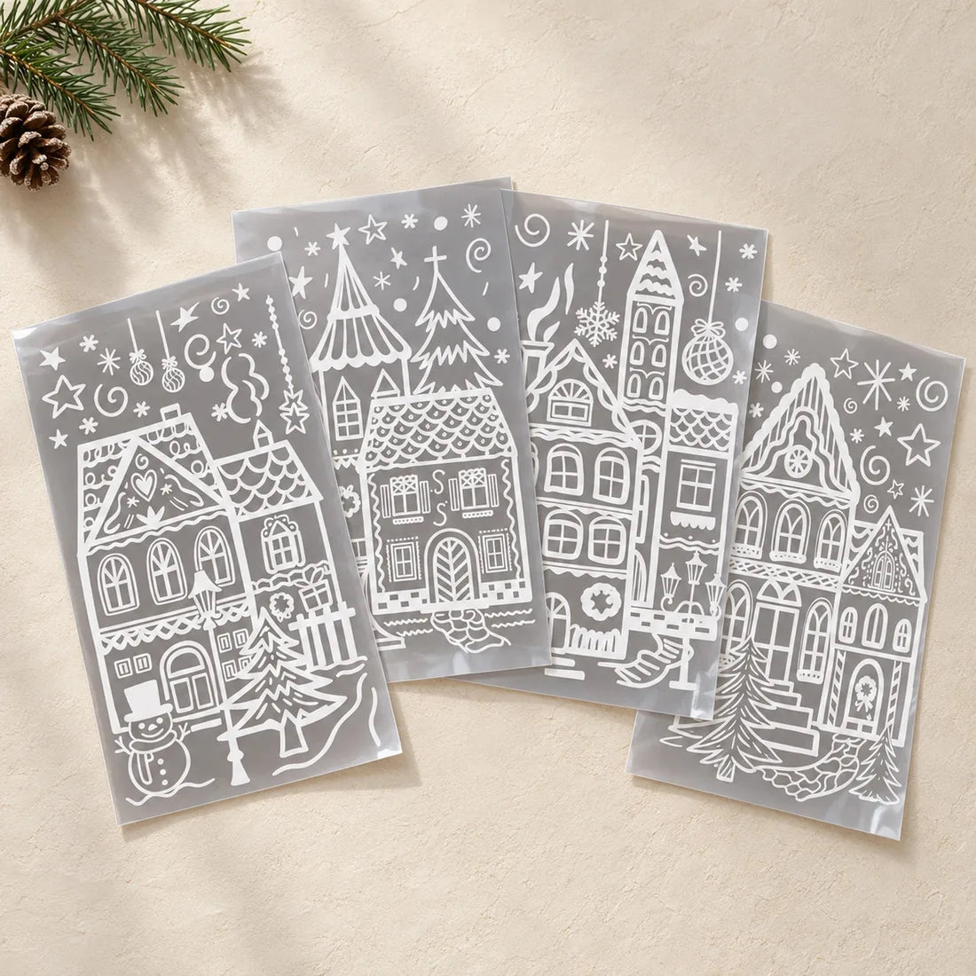 The four Jolly Window sheets laid out: a heart-gable house, a castle and church, a church-tower townhouse and a clock-gable house in white line art